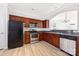 Well-lit kitchen features stainless steel appliances, wood cabinets, and granite countertops at 7364 Laurel Valley Rd, Charlotte, NC 28273
