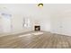 Bright living room with a fireplace and access to the outdoor patio at 7364 Laurel Valley Rd, Charlotte, NC 28273