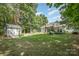 Lush backyard featuring mature trees, a storage shed, and a beautifully maintained lawn at 7913 Buena Vista Dr, Denver, NC 28037