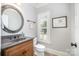 Charming powder room boasts a decorative mirror, granite countertop, and ample lighting at 7913 Buena Vista Dr, Denver, NC 28037