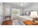 Comfortable bedroom with hardwood floors, and built-in bookcase, filled with natural light at 7913 Buena Vista Dr, Denver, NC 28037