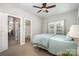 Cozy bedroom showing neutral carpet, a comfortable bed, and a window that provides plenty of natural light at 7913 Buena Vista Dr, Denver, NC 28037