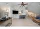 Inviting bonus room featuring neutral carpet, a ceiling fan, and a comfortable seating area. Stairway access on the right at 7913 Buena Vista Dr, Denver, NC 28037