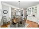 Cozy dining area with wood table adjacent to kitchen and a view into the living room at 7913 Buena Vista Dr, Denver, NC 28037