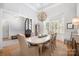 Bright dining room featuring wood floors, a wooden table, and a stunning globe chandelier at 7913 Buena Vista Dr, Denver, NC 28037