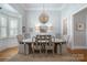 Elegant dining room with modern decor, neutral walls, and an ornate chandelier at 7913 Buena Vista Dr, Denver, NC 28037