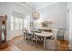 Traditional dining room with neutral tones, a large window, and a decorative chandelier at 7913 Buena Vista Dr, Denver, NC 28037