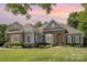 Charming single-story home featuring stone accents, manicured landscaping, and a warm, inviting entrance at 7913 Buena Vista Dr, Denver, NC 28037