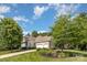 Charming home showcasing lush landscaping and a well-manicured lawn, adding to its curb appeal at 7913 Buena Vista Dr, Denver, NC 28037