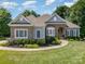 Beautifully landscaped front yard with a well-maintained lawn, stone accents, and a welcoming entrance at 7913 Buena Vista Dr, Denver, NC 28037