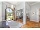Elegant foyer showcasing hardwood floors, an arched doorway, and views into the dining and living areas at 7913 Buena Vista Dr, Denver, NC 28037