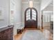 Inviting foyer featuring hardwood floors, a grand front door, elegant lighting, and views into other rooms at 7913 Buena Vista Dr, Denver, NC 28037