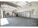 Spacious garage featuring an epoxy floor, ample storage cabinets, and a well-lit interior with an open door at 7913 Buena Vista Dr, Denver, NC 28037