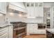 Gourmet kitchen featuring stainless steel range, white cabinets, and subway tile backsplash at 7913 Buena Vista Dr, Denver, NC 28037