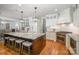 Well-lit open kitchen with an island, white cabinetry, and stainless steel appliances at 7913 Buena Vista Dr, Denver, NC 28037
