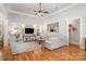 Bright living room with wood floors, neutral decor, large windows, and a comfortable seating arrangement at 7913 Buena Vista Dr, Denver, NC 28037