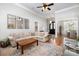 Cozy living room with hardwood floors, a comfortable sofa, and an open layout leading to the dining area at 7913 Buena Vista Dr, Denver, NC 28037