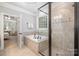 Luxurious main bathroom featuring a soaking tub, glass shower, and tiled accents at 7913 Buena Vista Dr, Denver, NC 28037