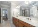 Elegant bathroom with double sinks, tiled floors, and a glass-enclosed shower at 7913 Buena Vista Dr, Denver, NC 28037