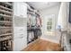 Bright walk-in closet with custom shelving, drawers, hanging racks, and a window that provides natural light at 7913 Buena Vista Dr, Denver, NC 28037