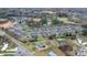 Aerial view showcases the layout of the community, highlighting the homes, green spaces, and pond feature at 824 Wynnshire Dr # D, Hickory, NC 28601