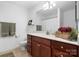 Nicely decorated bathroom with wood vanity, decorative plants, and well-placed towel racks at 824 Wynnshire Dr # D, Hickory, NC 28601