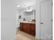 Bright bathroom with a wood vanity, decorative plants, and a neutral color palette at 824 Wynnshire Dr # D, Hickory, NC 28601