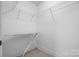 Walk-in closet with shelves and a hanging rod, complete with ironing board at 824 Wynnshire Dr # D, Hickory, NC 28601