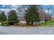 Street view of the Wynnsridge Ridge neighborhood sign nestled among trees and well-manicured landscaping at 824 Wynnshire Dr # D, Hickory, NC 28601