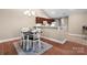 Cozy dining area featuring modern chandelier, natural light, and dark wood floors at 824 Wynnshire Dr # D, Hickory, NC 28601