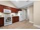 Bright kitchen boasts wooden cabinets, modern appliances, a white refrigerator, and neutral tile flooring at 824 Wynnshire Dr # D, Hickory, NC 28601