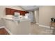 Functional kitchen featuring wooden cabinetry, modern appliances, and tile flooring at 824 Wynnshire Dr # D, Hickory, NC 28601