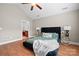 Serene main bedroom with hardwood floors, tufted bed, neutral walls, and a glimpse into the bathroom at 824 Wynnshire Dr # D, Hickory, NC 28601