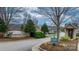 Street view of the neighborhood entrance sign nestled among mature trees and lush landscaping, creating a welcoming ambiance at 824 Wynnshire Dr # D, Hickory, NC 28601