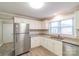 Well-lit kitchen features white cabinets, granite countertops, and stainless steel appliances at 904 Indiana St, Kannapolis, NC 28083