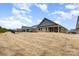 Backyard view of the homes, with covered patio and fence, and partly cloudy sky at 9534 Liberty Hill Dr # 196, Mint Hill, NC 28227