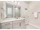 Bright bathroom featuring single sink with white countertop, a decorative mirror, and towel and robe racks at 9534 Liberty Hill Dr # 196, Mint Hill, NC 28227