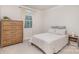 Cozy bedroom with a wooden dresser, a comfortable bed, and natural light at 9534 Liberty Hill Dr # 196, Mint Hill, NC 28227