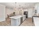 Modern kitchen with a large island, white cabinets, stainless steel appliances, and an adjacent dining area for easy entertaining at 9534 Liberty Hill Dr # 196, Mint Hill, NC 28227