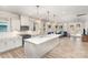 Open-concept kitchen featuring a large island, stainless steel appliances, and stylish pendant lighting, flowing into the living area at 9534 Liberty Hill Dr # 196, Mint Hill, NC 28227