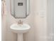 Powder room with a pedestal sink, modern fixtures, and neutral decor at 9534 Liberty Hill Dr # 196, Mint Hill, NC 28227