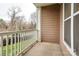 Cozy outdoor balcony area with white railing overlooking a serene neighborhood setting at 1000 E Woodlawn Rd # 110, Charlotte, NC 28209