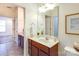 Bathroom featuring a single sink vanity and access to the bedroom and shower at 1000 E Woodlawn Rd # 110, Charlotte, NC 28209
