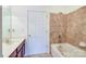 Bathroom featuring a single sink vanity and a tiled shower and tub at 1000 E Woodlawn Rd # 110, Charlotte, NC 28209