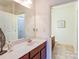 Bathroom featuring a single sink vanity and access to the water closet at 1000 E Woodlawn Rd # 110, Charlotte, NC 28209