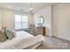 Bedroom with neutral carpet, a bright window, modern decor, and a hanging chandelier at 1000 E Woodlawn Rd # 110, Charlotte, NC 28209