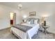 Comfortable bedroom with chandelier lighting, side tables and a connected bath at 1000 E Woodlawn Rd # 110, Charlotte, NC 28209