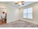 Bedroom featuring a ceiling fan, a window with blinds, and access to the dining room at 1000 E Woodlawn Rd # 110, Charlotte, NC 28209