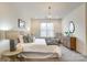 Bedroom features neutral tones, large window for light, and a hanging chandelier at 1000 E Woodlawn Rd # 110, Charlotte, NC 28209