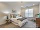 Cozy bedroom boasts a chandelier, window views, and calming neutral color palette at 1000 E Woodlawn Rd # 110, Charlotte, NC 28209